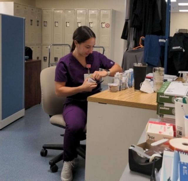 Intern at clinical rotation taste-testing oral nutrition supplements.